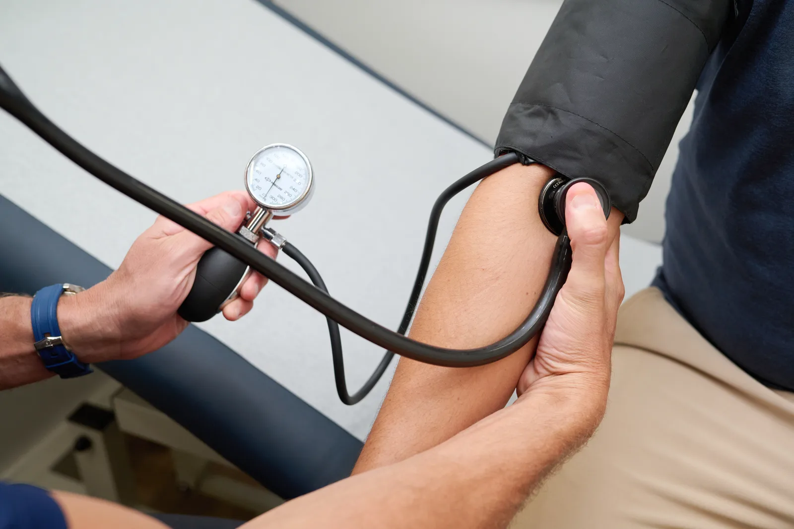A PrimeCare clinician checking a member's blood pressure inside the Mobile Medical Office